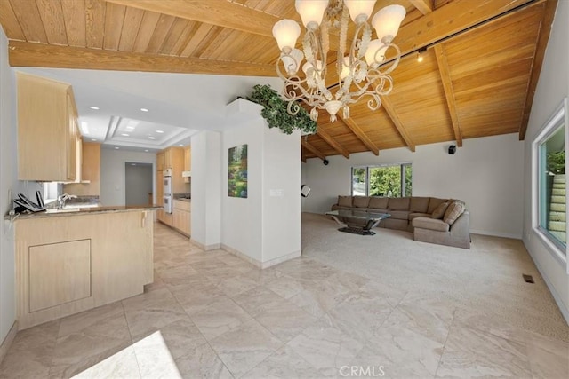 unfurnished living room with sink, a chandelier, wood ceiling, and vaulted ceiling with beams