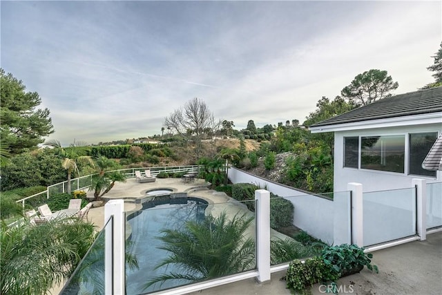 view of pool with an in ground hot tub and a patio