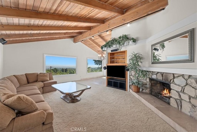 living room featuring vaulted ceiling with beams, a fireplace, rail lighting, carpet flooring, and wooden ceiling