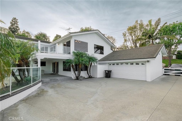 view of front of home with a balcony and a garage