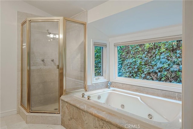 bathroom with tile patterned floors, separate shower and tub, and lofted ceiling