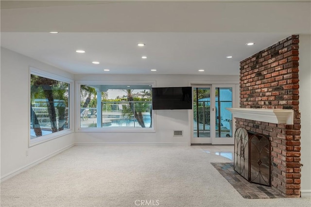 unfurnished living room with a fireplace and carpet floors