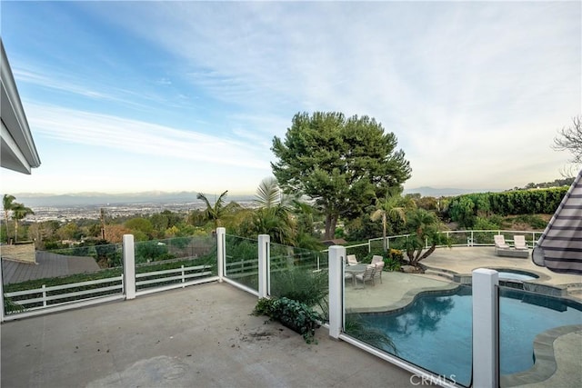 view of swimming pool with a patio area and a hot tub