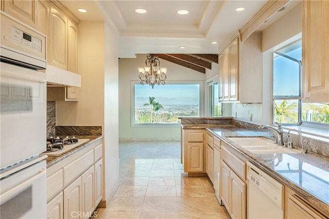 kitchen featuring sink, white appliances, decorative light fixtures, and plenty of natural light