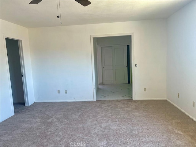 carpeted empty room with ceiling fan