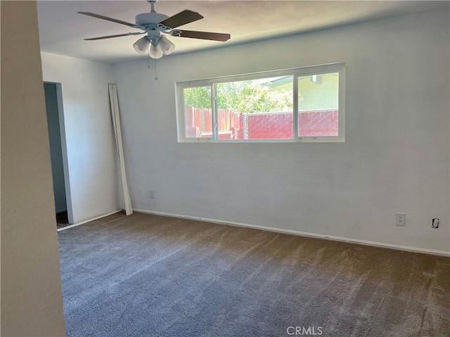 carpeted empty room featuring ceiling fan