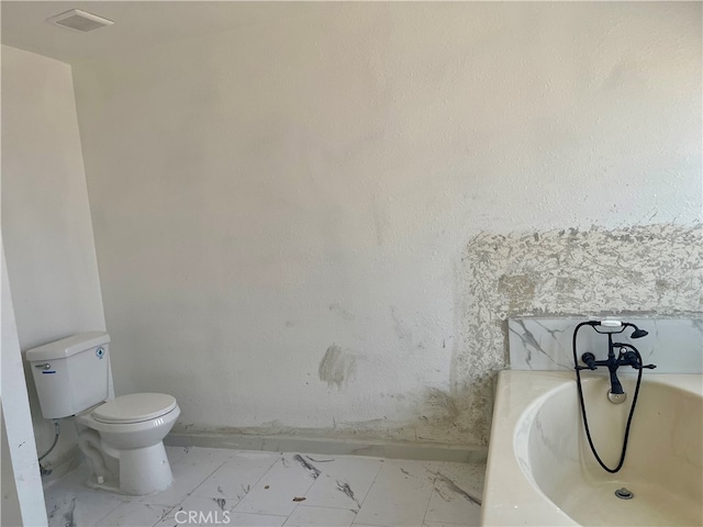 bathroom with a tub and toilet