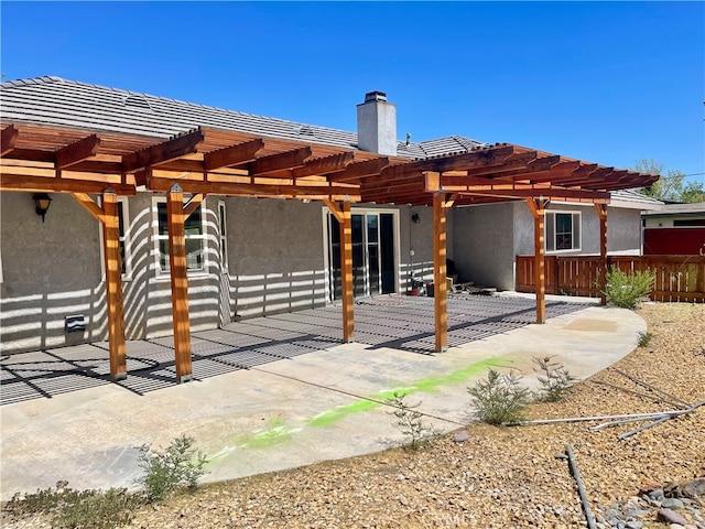 back of property featuring a patio and a pergola