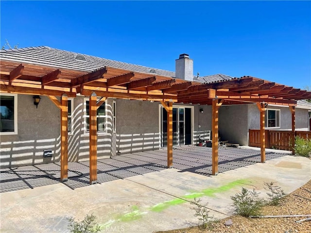 back of house with a pergola and a patio area