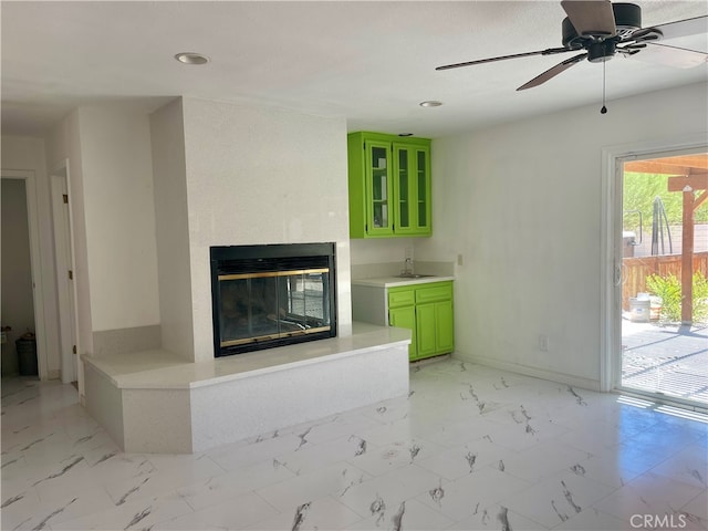 unfurnished living room featuring ceiling fan and wet bar