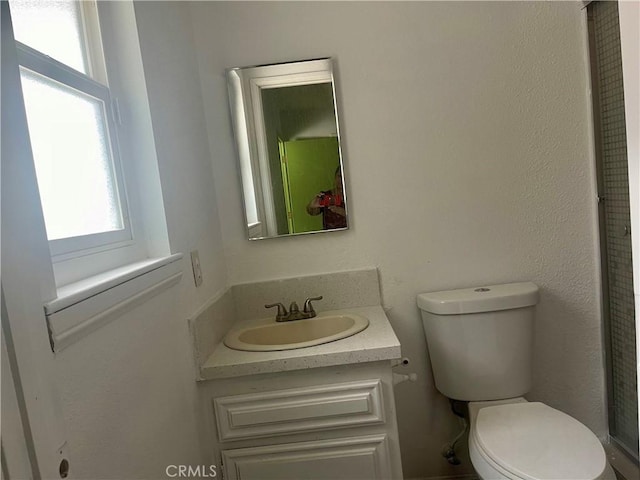 bathroom featuring vanity and toilet