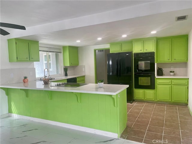 kitchen featuring a breakfast bar, sink, black appliances, and kitchen peninsula