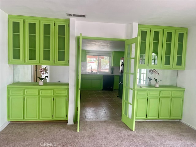 kitchen with light colored carpet, stainless steel refrigerator, and sink