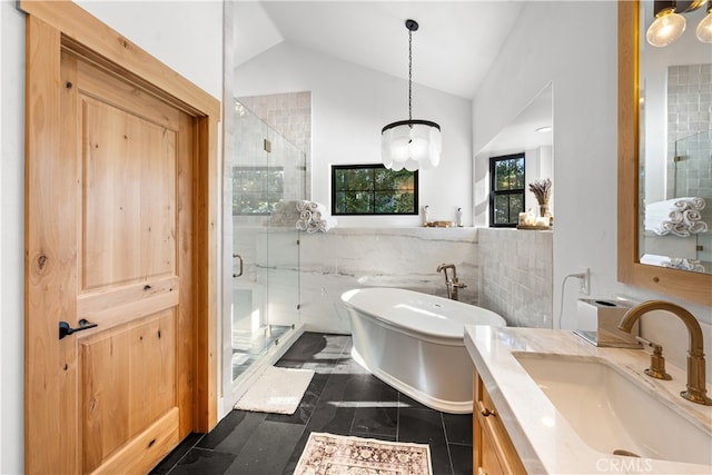 bathroom with vanity, shower with separate bathtub, lofted ceiling, and tile walls