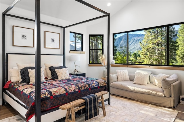 bedroom with light hardwood / wood-style floors and vaulted ceiling