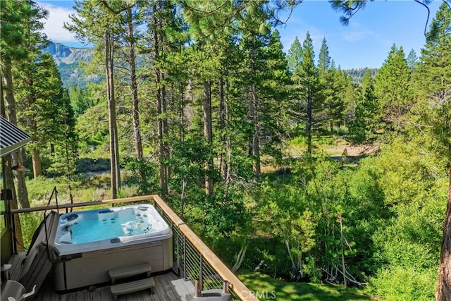 wooden balcony featuring a deck and a hot tub