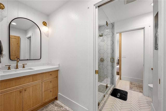 bathroom featuring an enclosed shower, toilet, and vanity