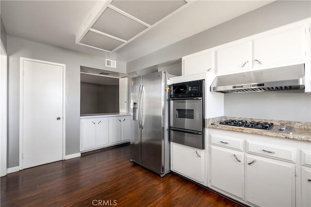 kitchen with white cabinets, dark hardwood / wood-style flooring, and appliances with stainless steel finishes