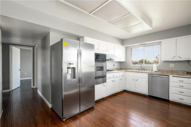 kitchen featuring dark hardwood / wood-style flooring, white cabinets, and appliances with stainless steel finishes