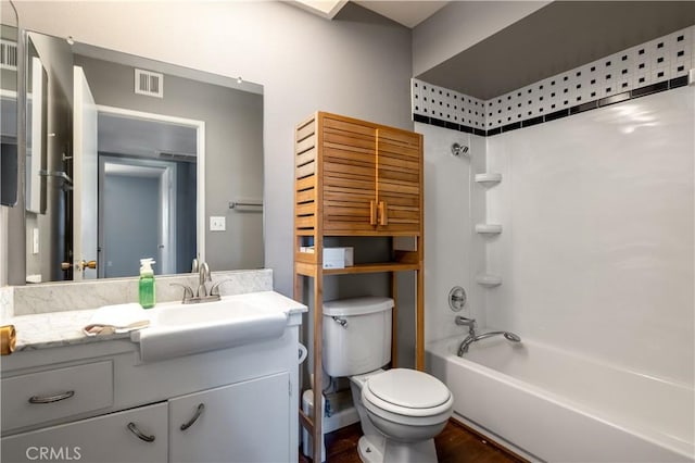 full bathroom with shower / tub combination, vanity, toilet, and hardwood / wood-style floors