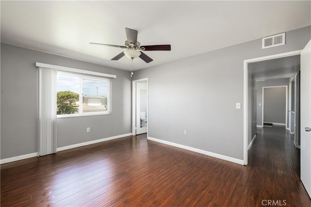 empty room featuring ceiling fan and dark hardwood / wood-style floors