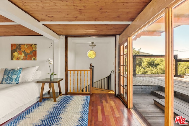 interior space with hardwood / wood-style flooring, wooden ceiling, and beamed ceiling