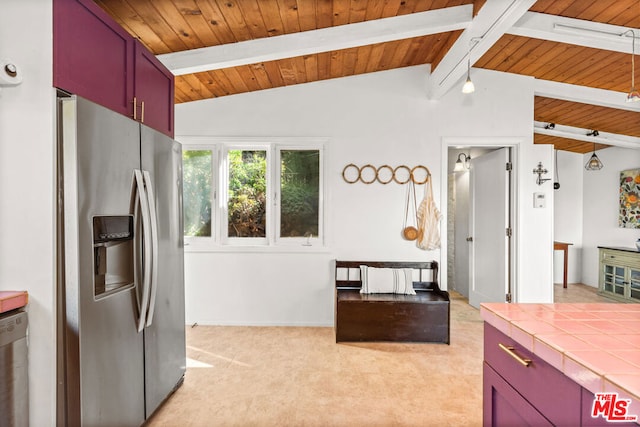 kitchen featuring appliances with stainless steel finishes, tile counters, lofted ceiling with beams, and wooden ceiling