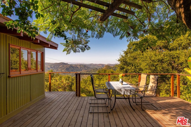 wooden deck with a mountain view