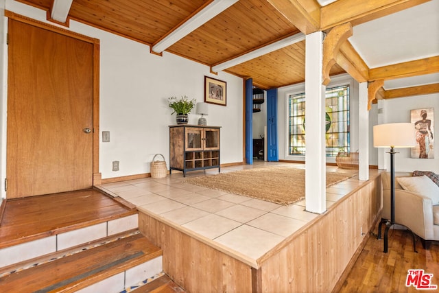 interior space with beam ceiling, wooden ceiling, and hardwood / wood-style flooring