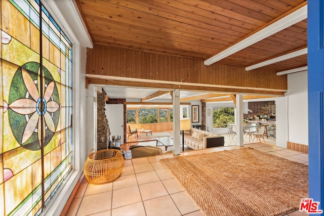 sunroom featuring beamed ceiling and wooden ceiling