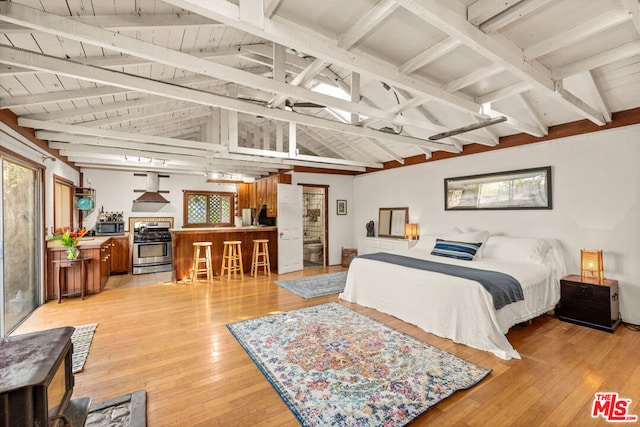 bedroom featuring lofted ceiling with beams, wooden ceiling, and light wood-type flooring