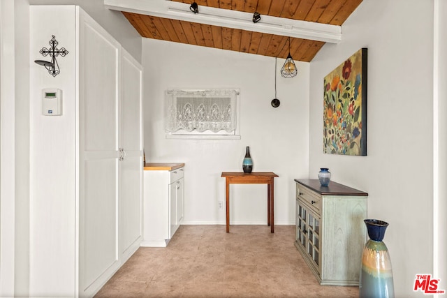 hallway with wood ceiling and lofted ceiling with beams