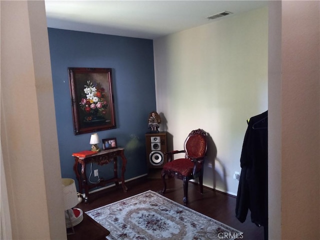 sitting room with dark hardwood / wood-style flooring