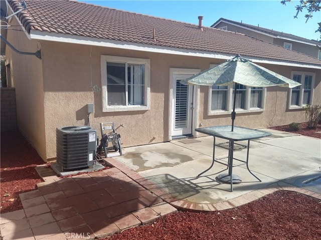 back of property featuring central AC unit and a patio area