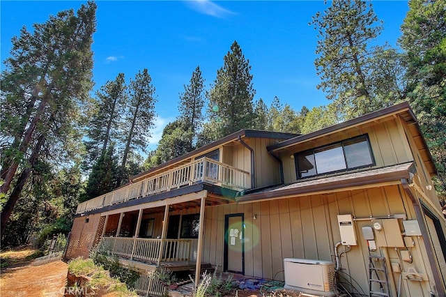 back of property featuring a balcony