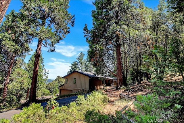 view of home's exterior with a garage and an outbuilding