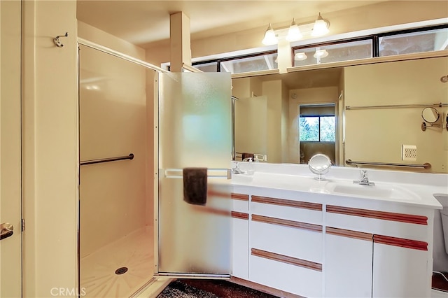 bathroom with walk in shower and vanity