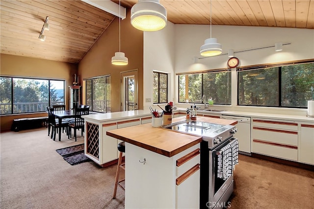 kitchen featuring white cabinets, pendant lighting, electric range, and a center island