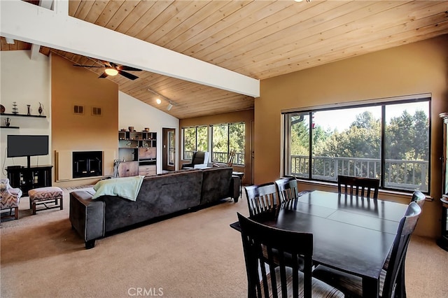 carpeted dining area featuring wood ceiling, vaulted ceiling with beams, and ceiling fan