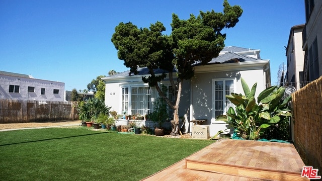 rear view of property featuring a lawn