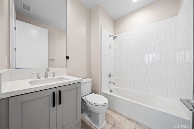 full bathroom featuring tile patterned floors, vanity, toilet, and tiled shower / bath