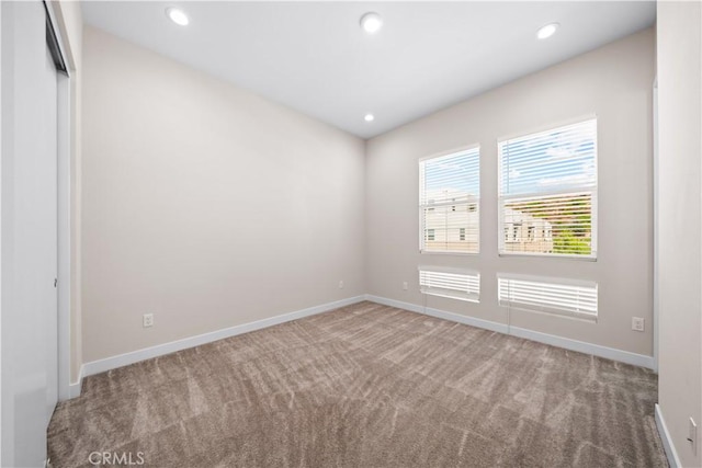 unfurnished room featuring carpet