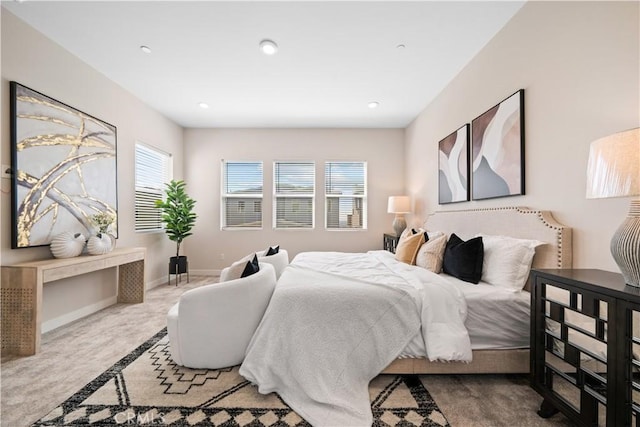 bedroom with light carpet and multiple windows