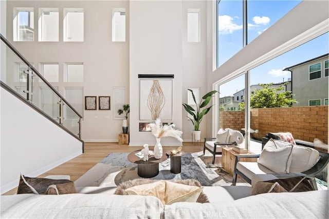 living room featuring a high ceiling and light wood-type flooring