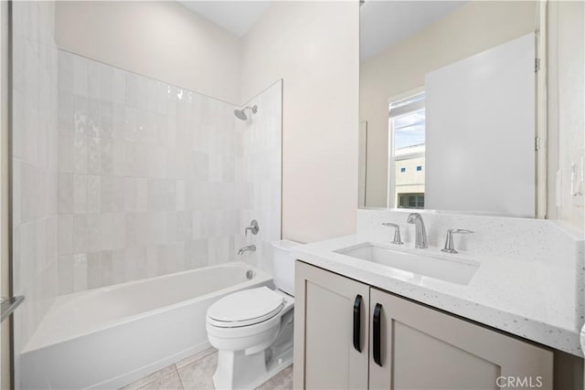 full bathroom featuring toilet, vanity, tile patterned floors, and tiled shower / bath