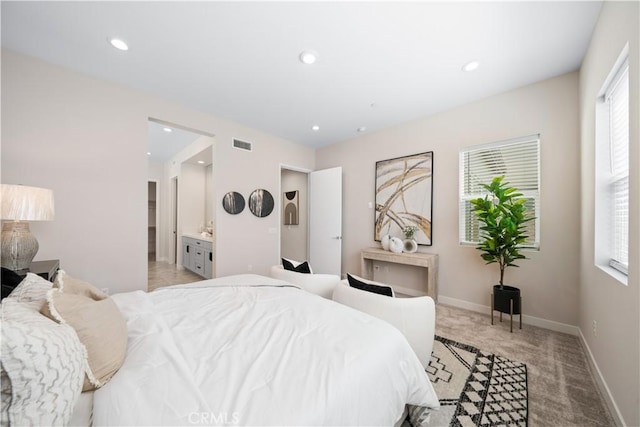 carpeted bedroom featuring ensuite bathroom