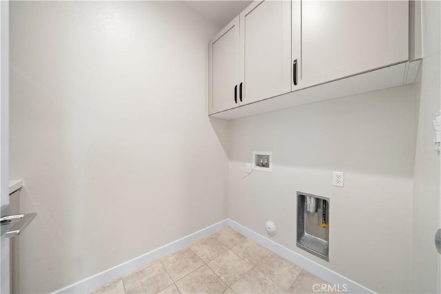 washroom with cabinets, washer hookup, gas dryer hookup, and light tile patterned flooring