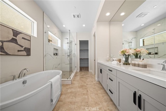 bathroom featuring vanity, tile patterned flooring, and plus walk in shower