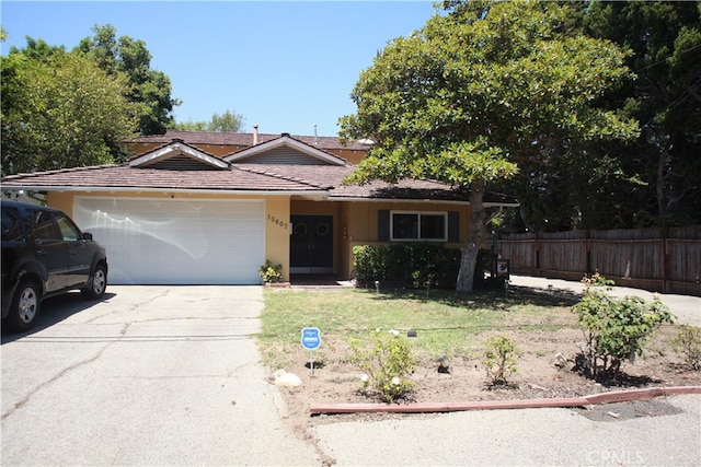 view of front of property with a front yard and a garage