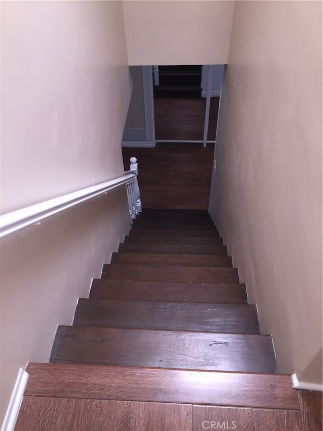 stairs featuring hardwood / wood-style floors